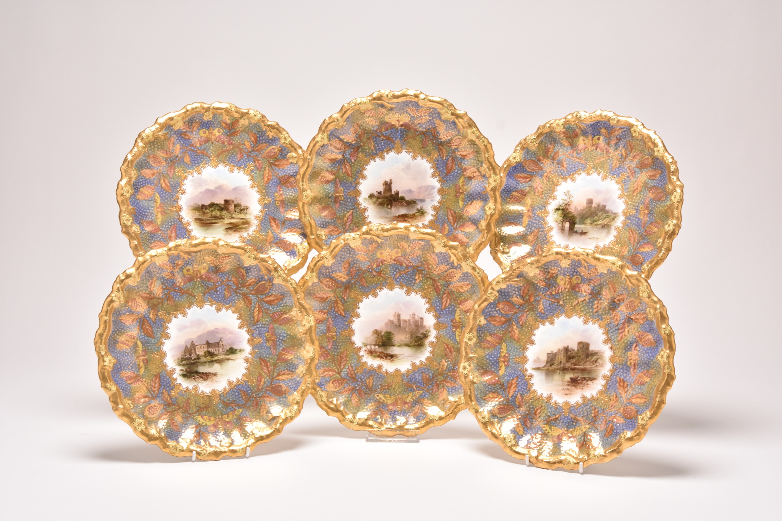 A set of named view Coalport dessert plates that sold for £420. Halls